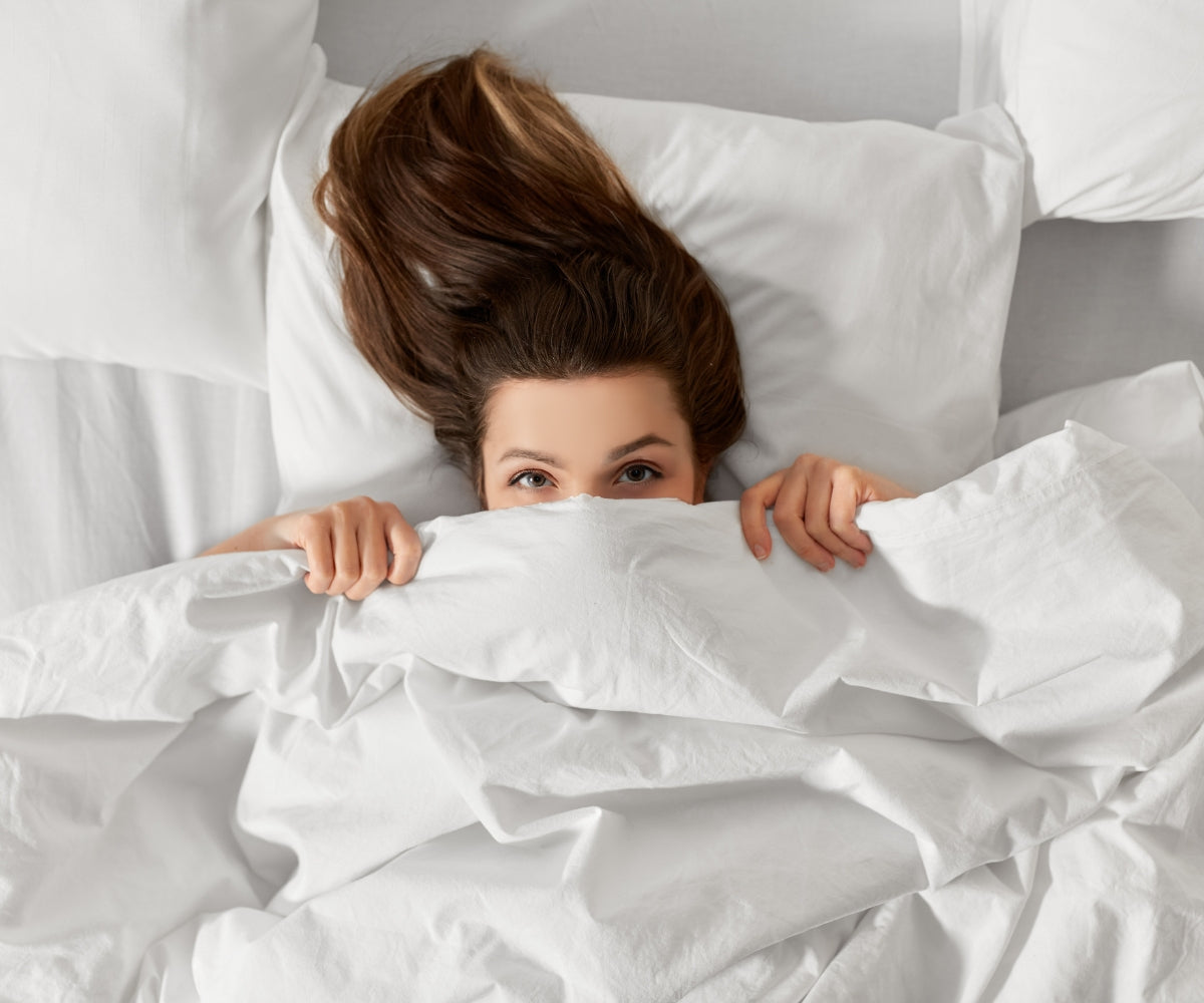Piumino letto Fiocco con la modella sotto le coperte