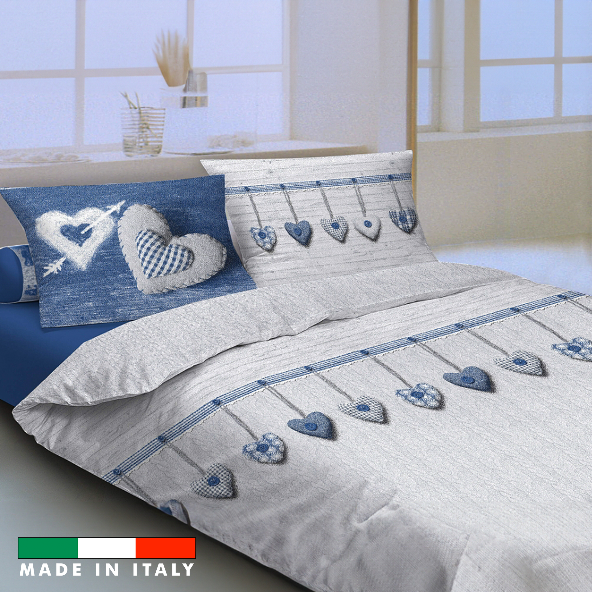 Parure copripiumino cuori appesi blu con federe e fantasia su un letto matrimoniale con lenzuolo sopra blu